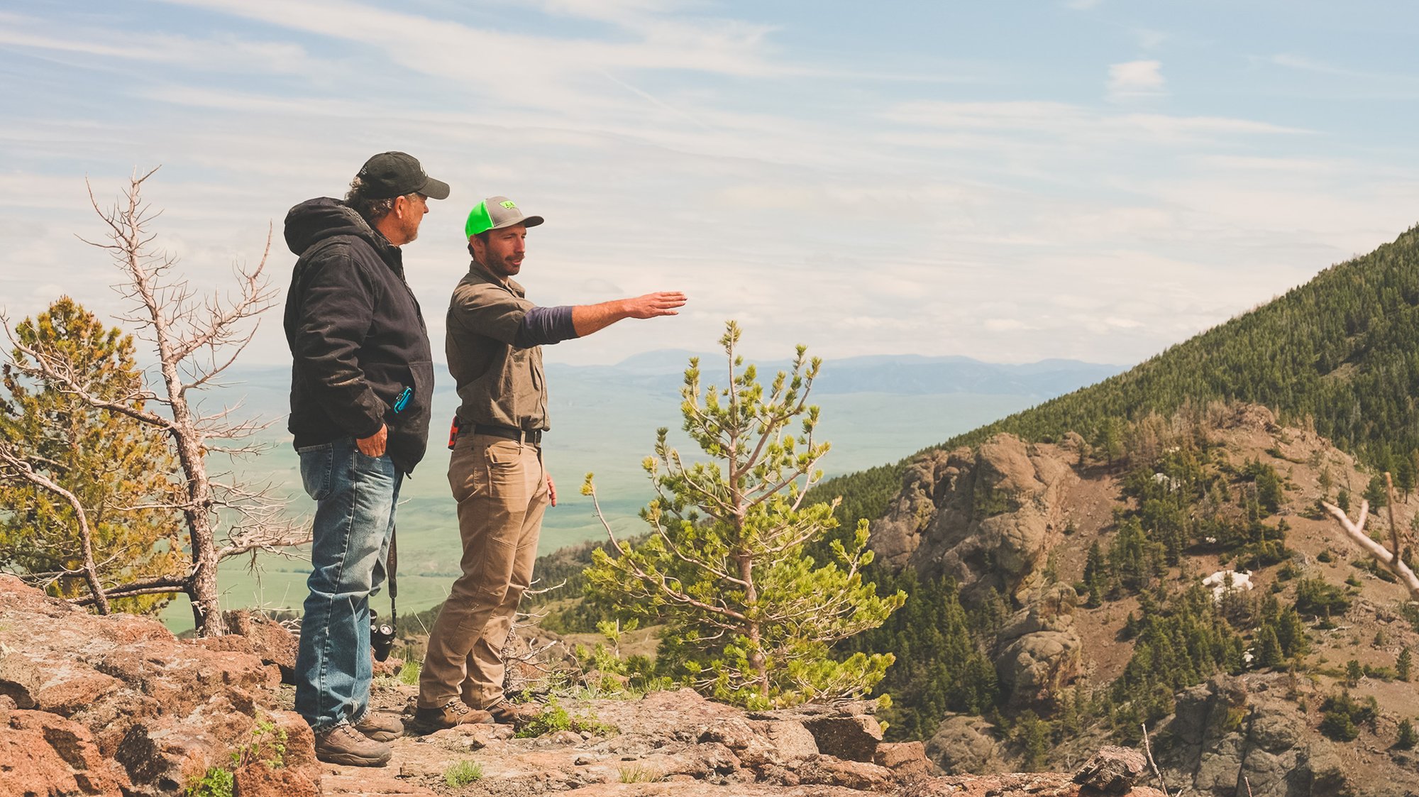 Sheep Creek Ranch landowner, Don Harland, standing beside his Forester, Zack Bashoor.